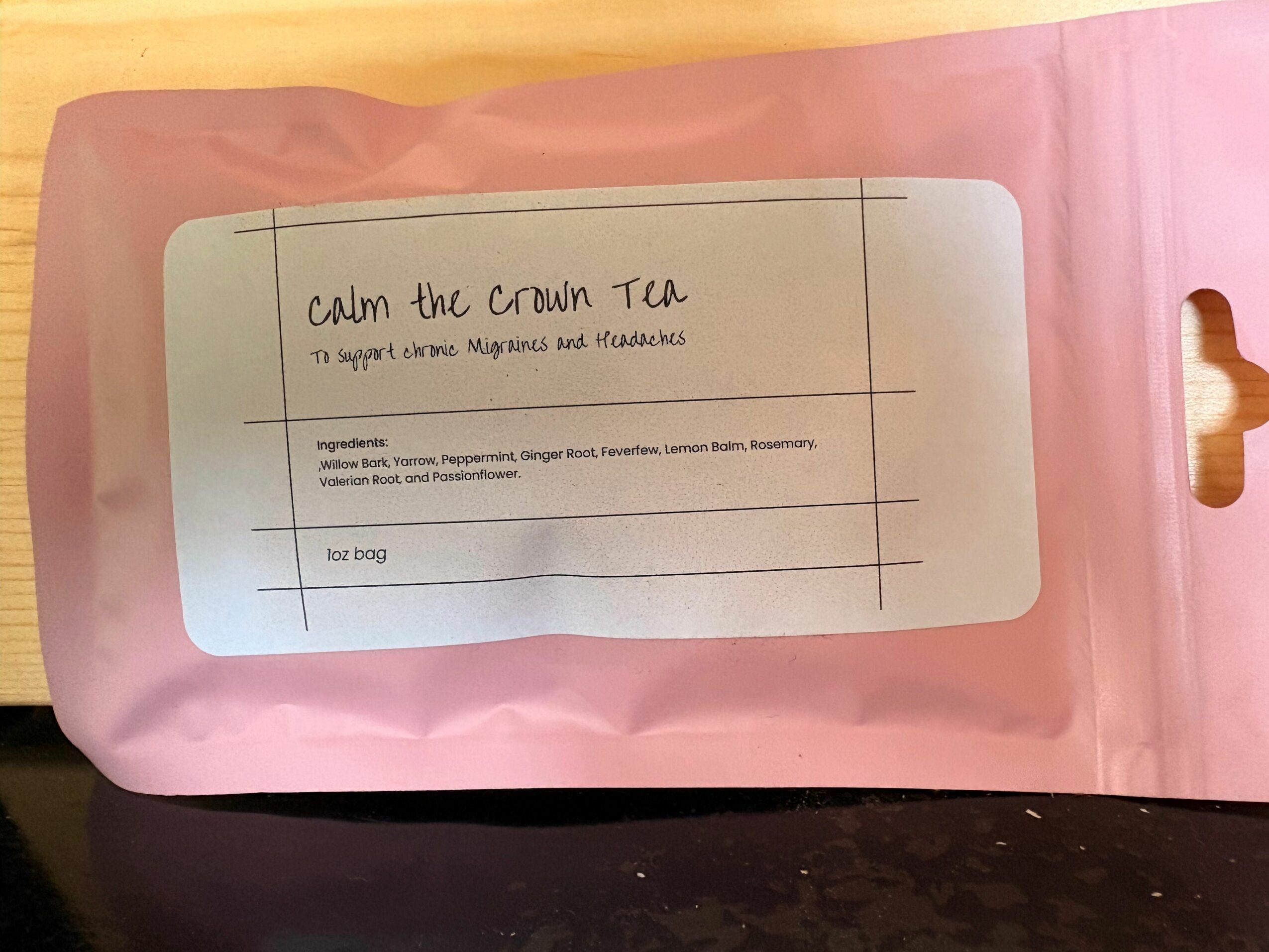 Pink package with a white label containing handwritten text and a list of ingredients.