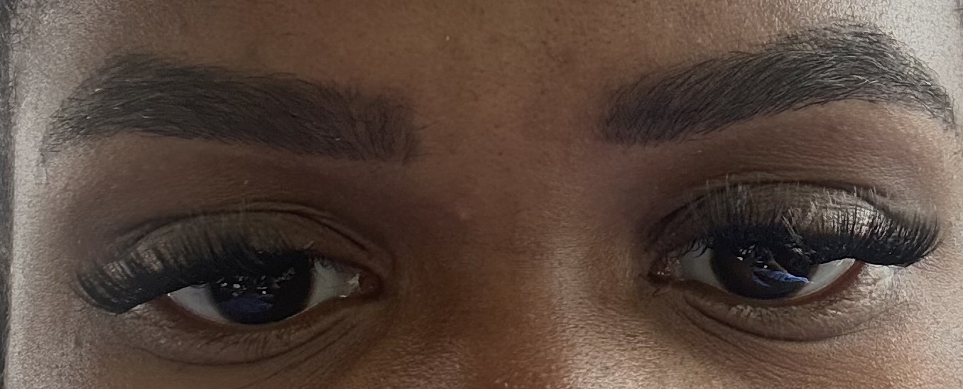 Close-up of person's eyes with makeup and well-groomed eyebrows.
