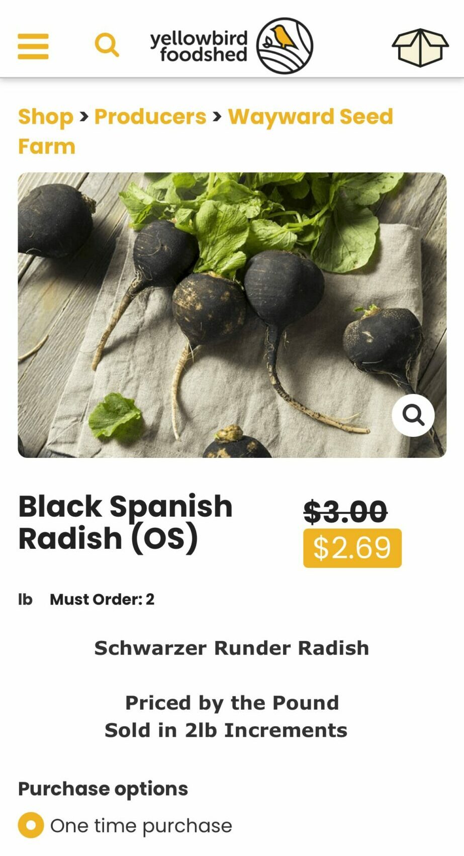 Black Spanish radish with green leaves on a wooden surface, priced at $2.69, originally $3.00, sold in 2 lb increments.