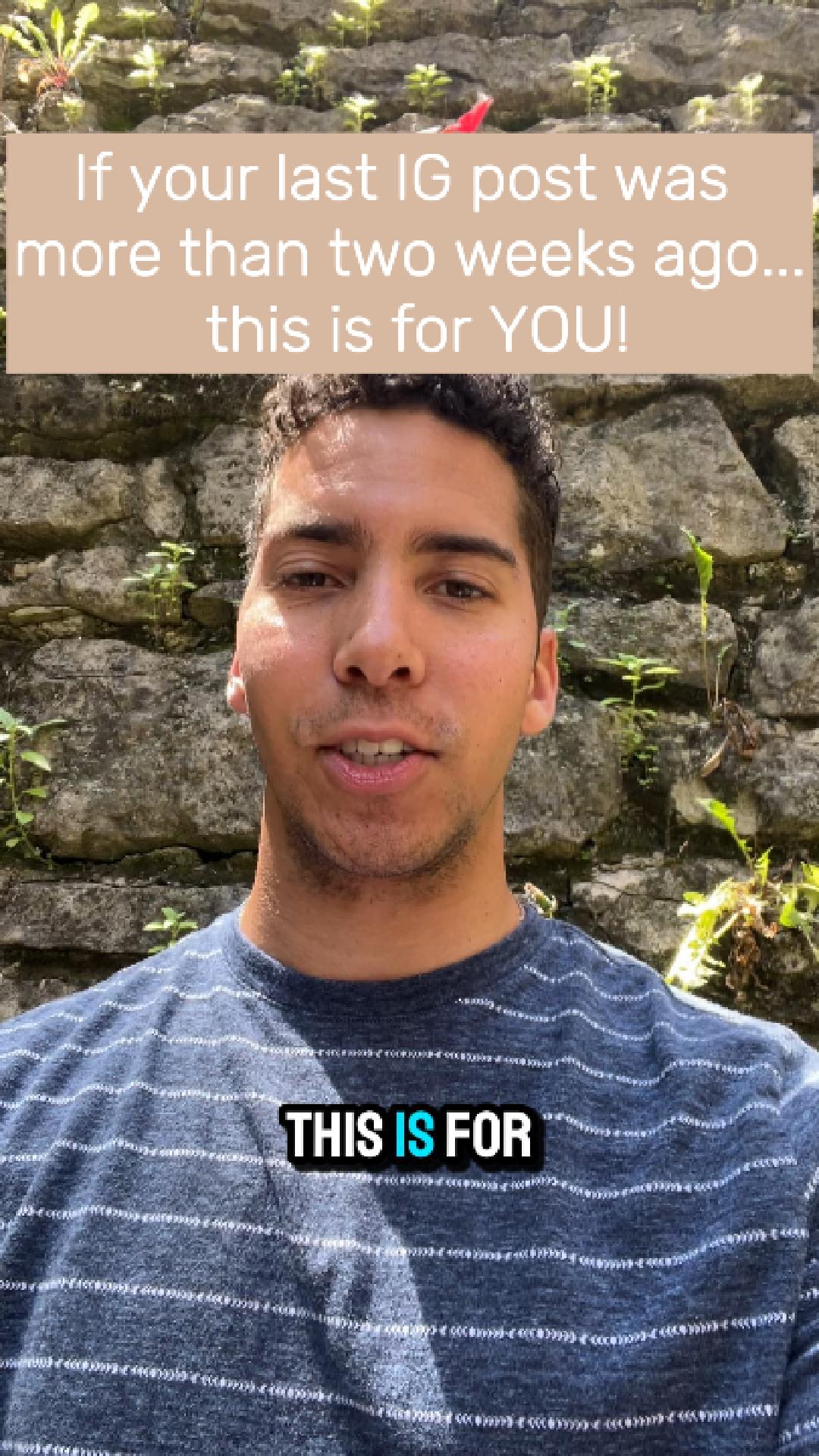 A young man with short dark hair and a striped shirt stands outdoors in front of a stone wall with greenery. Text overlay: 