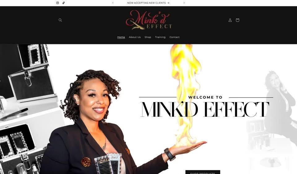 Woman with curly hair smiling, holding fire in her hand, website header with text 'MINKD EFFECT', black background.