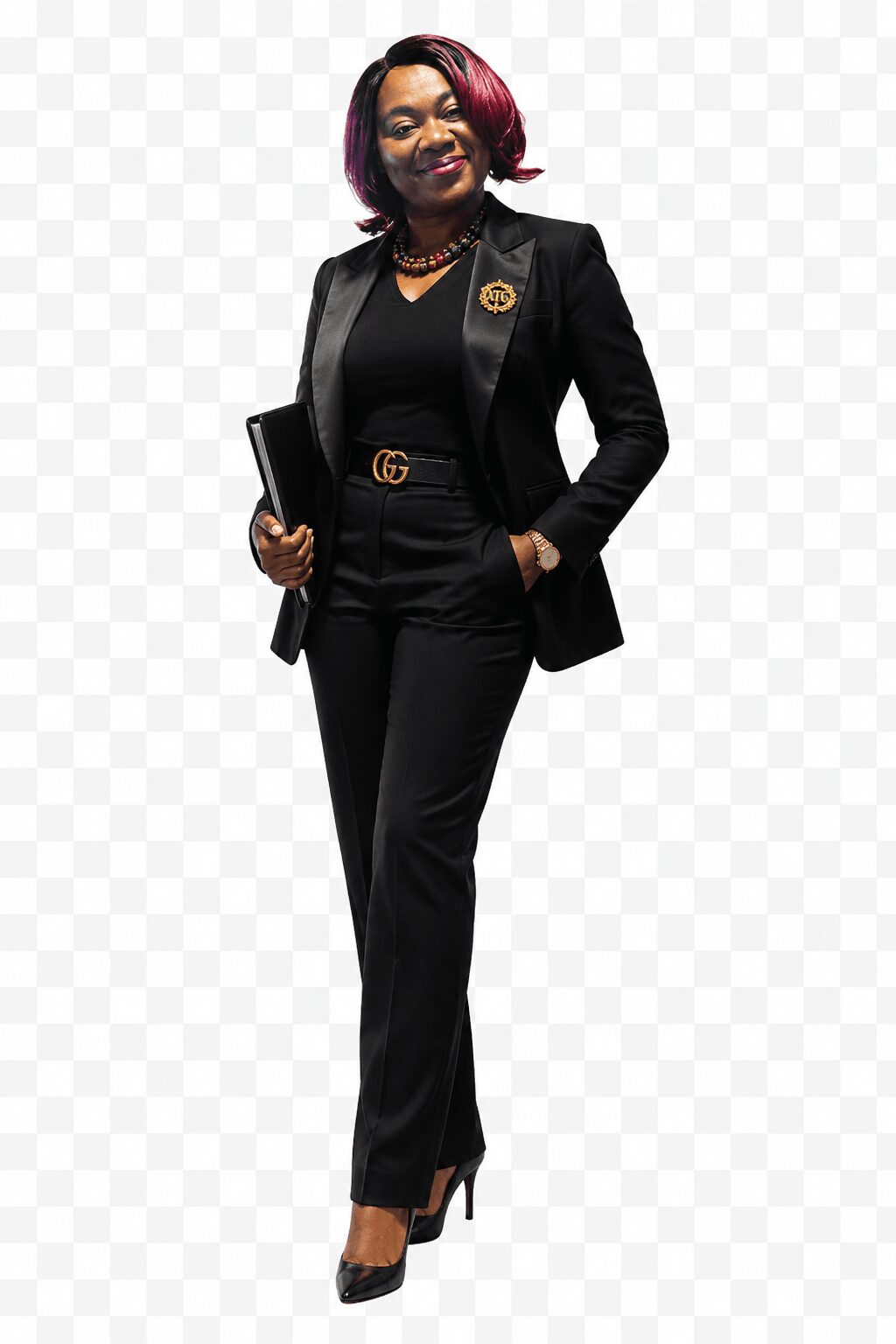 Confident woman in black suit holding a tablet, standing with one hand in pocket, smiling, with colorful hair.