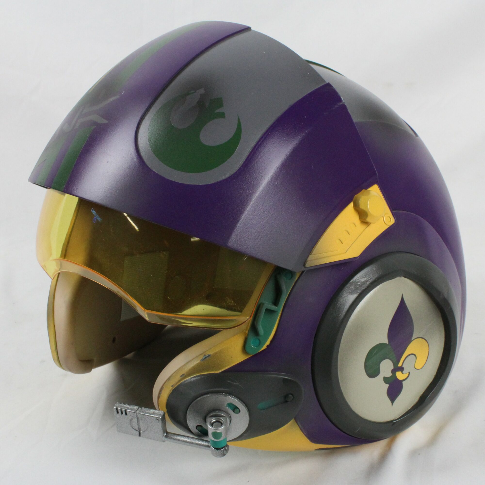 Purple and yellow helmet with a visor and a logo on the side, facing left.