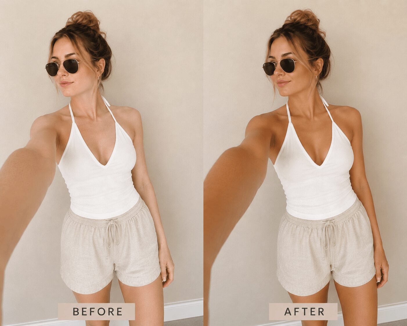 Woman in white top and beige shorts taking a selfie, wearing sunglasses, with hair in a bun, against a plain wall.