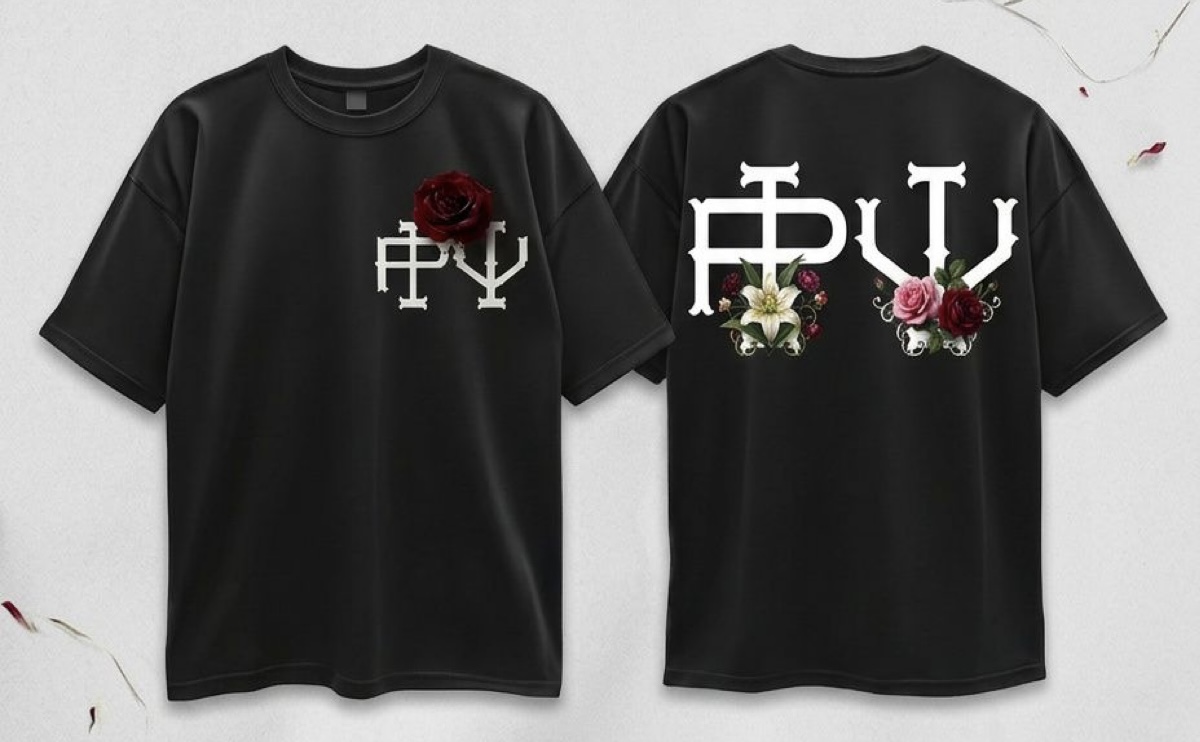 Black T-shirt with white text and floral decorations on front and back, flowers on the front and back, short sleeves.