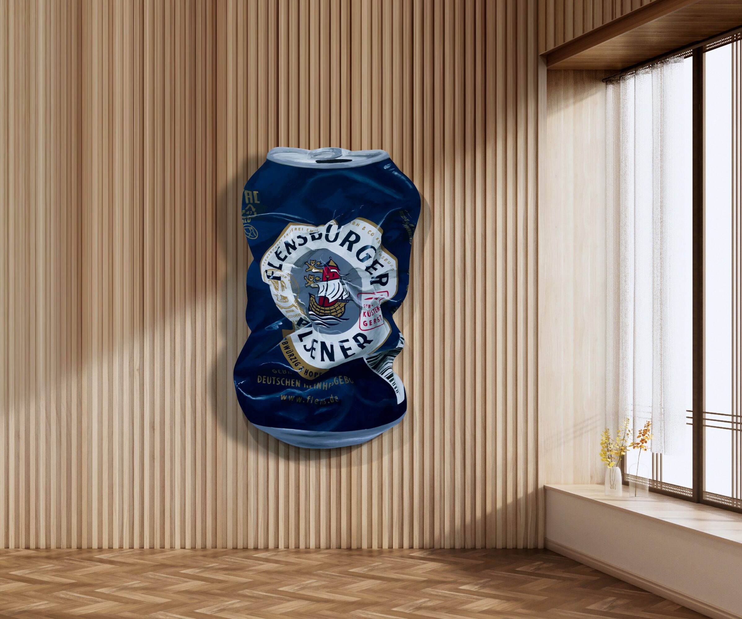 Crushed blue aluminum can with a logo, mounted on a wooden wall in a room with a window and curtains.