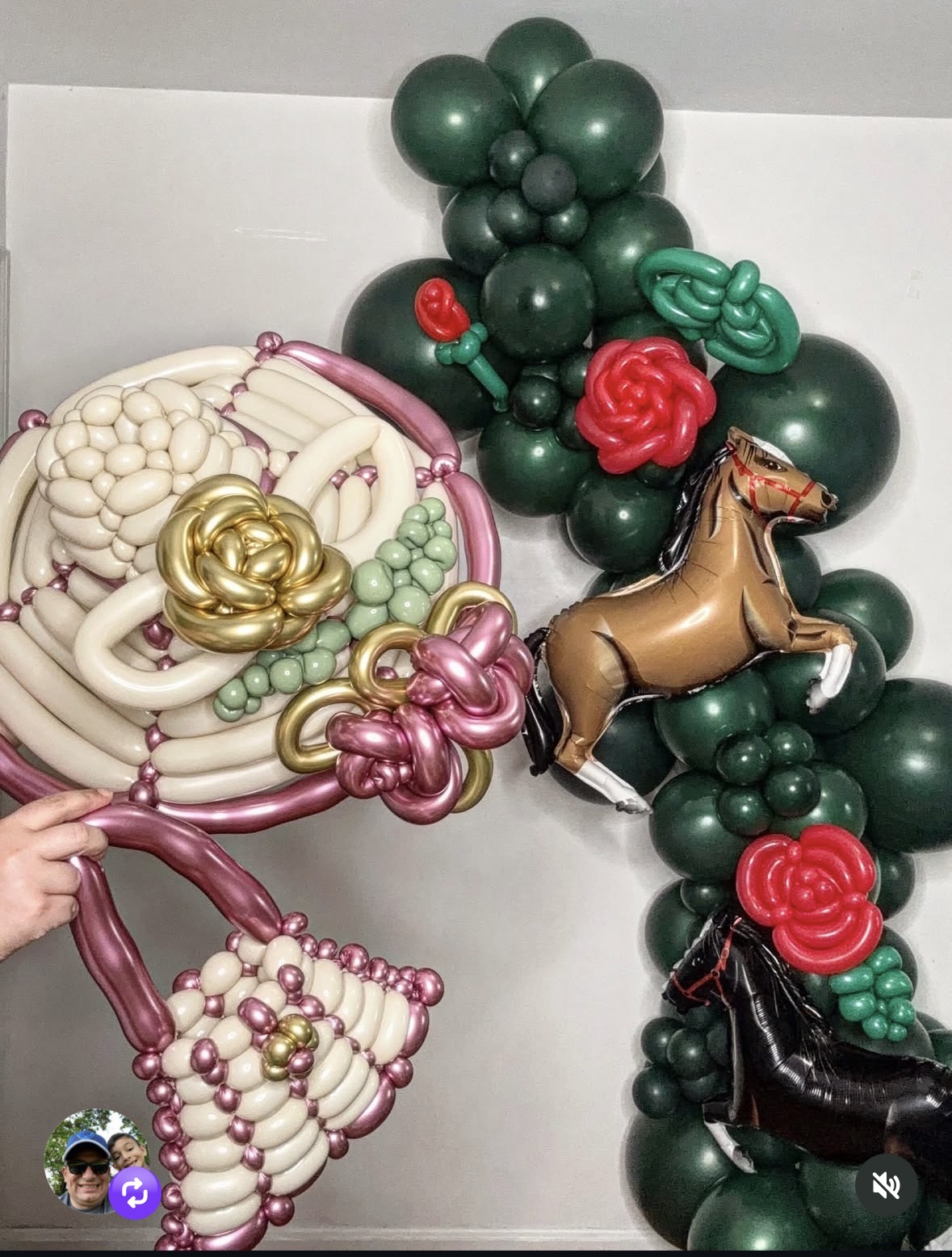 Balloon arrangement with a horse, roses, and various balloons in green, pink, white, and gold colors.