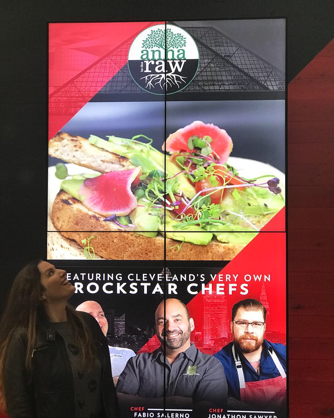 Four-panel digital display with food and chefs, featuring a logo at the top, and text about Cleveland's chefs.