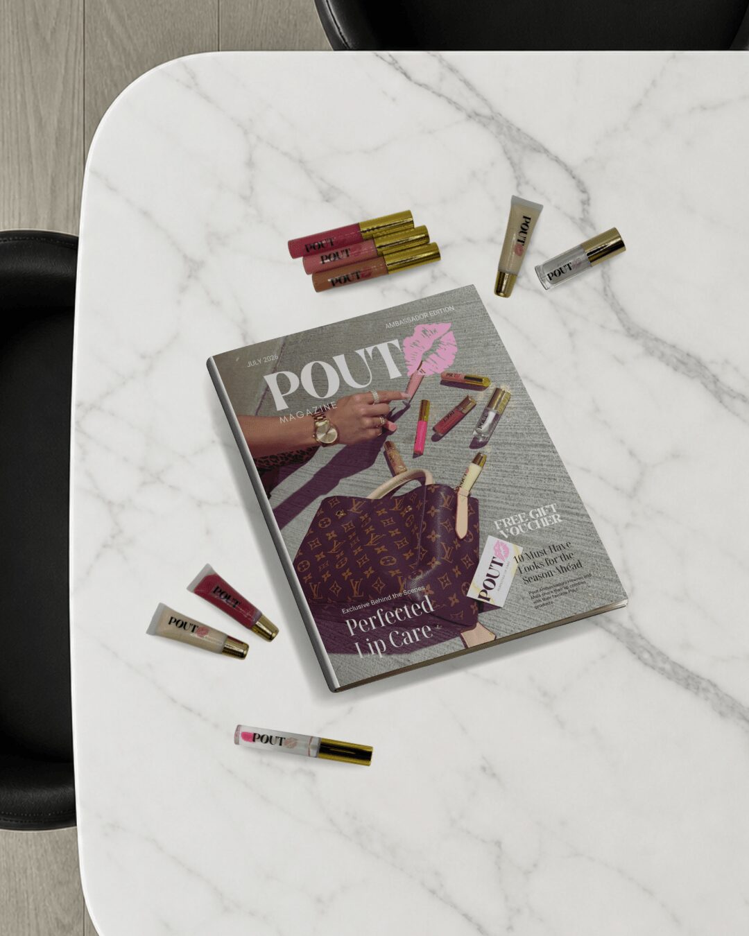 Magazine titled 'POUT' with lipstick and makeup items on a white marble table, surrounded by lipstick tubes.