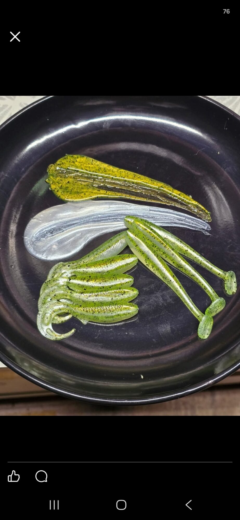 Sliced green chili peppers and a yellow zucchini in a black pan.