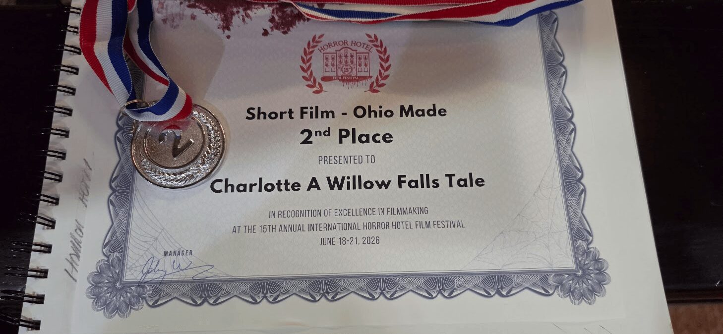 Certificate with medal and ribbon, awarded for second place in a short film contest, titled 'Charlotte A Willow Falls Tale'.