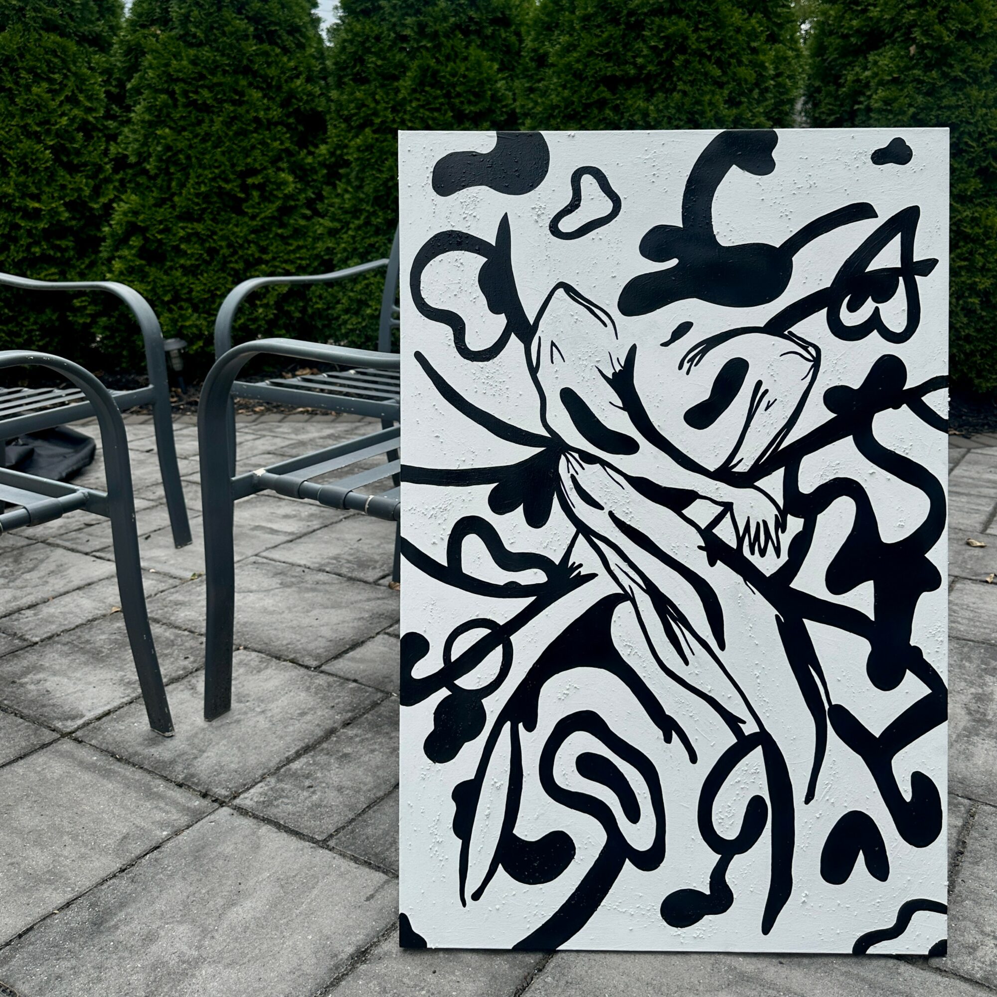 Black and white abstract drawing of a face with flowing lines and shapes, on a white background.