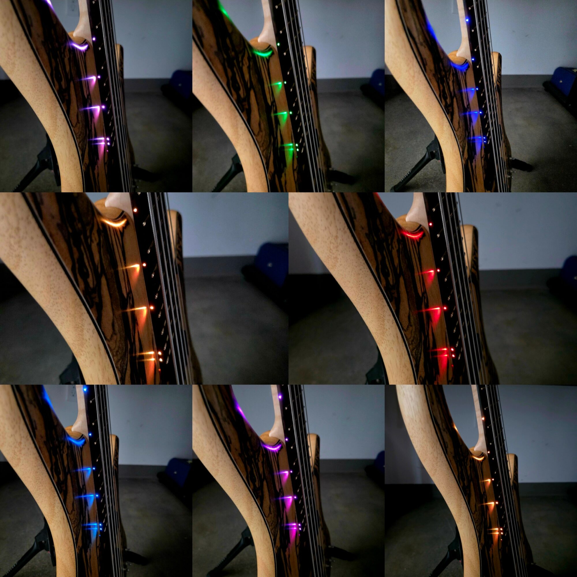 Close-up of a guitar neck with illuminated fret markers in various colors, including purple, green, blue, orange, red, and pink, against a dark background.