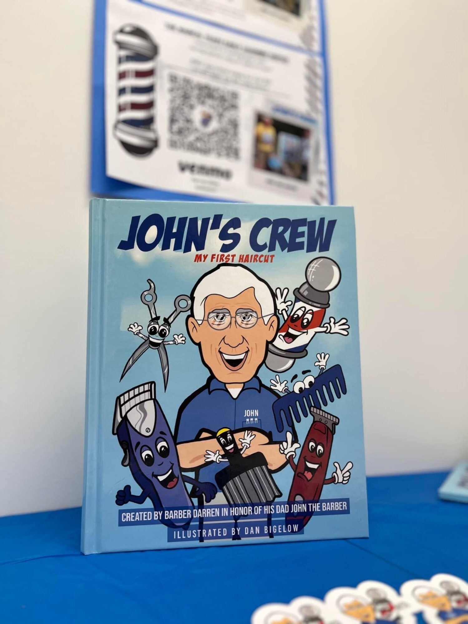Book cover titled 'John's Crew' featuring cartoon characters including a smiling man, a robot, a comb, and a spray bottle.