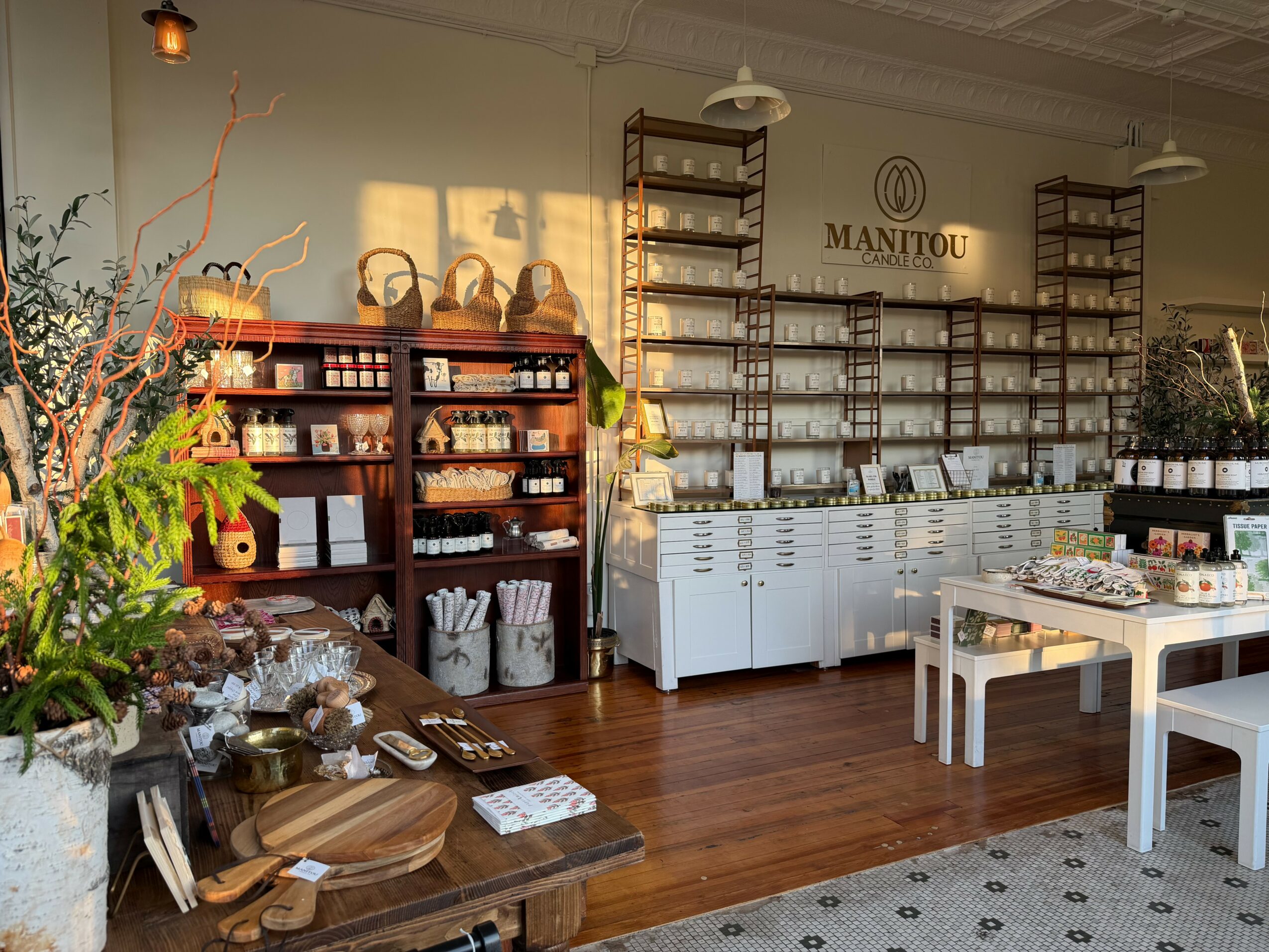 Interior of a store with shelves, tables, and plants, featuring a