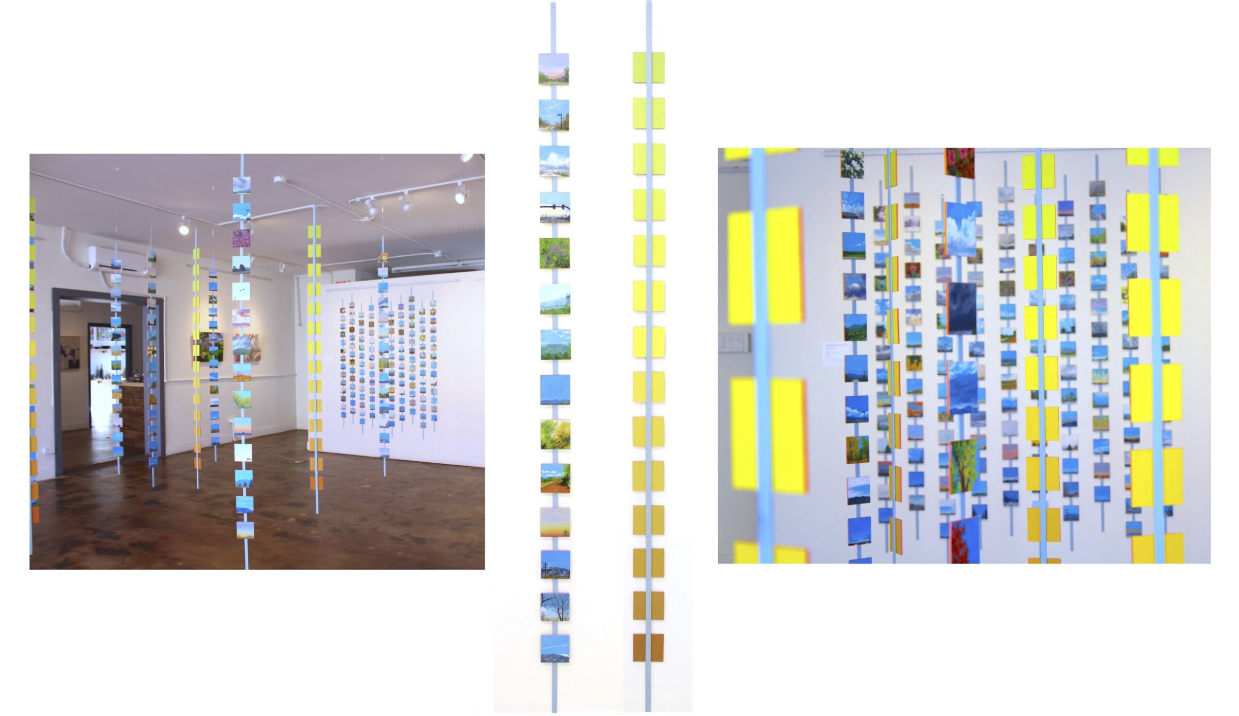 Installation with hanging colorful rectangular and square shapes in a gallery space, wooden floor, and ceiling lights.