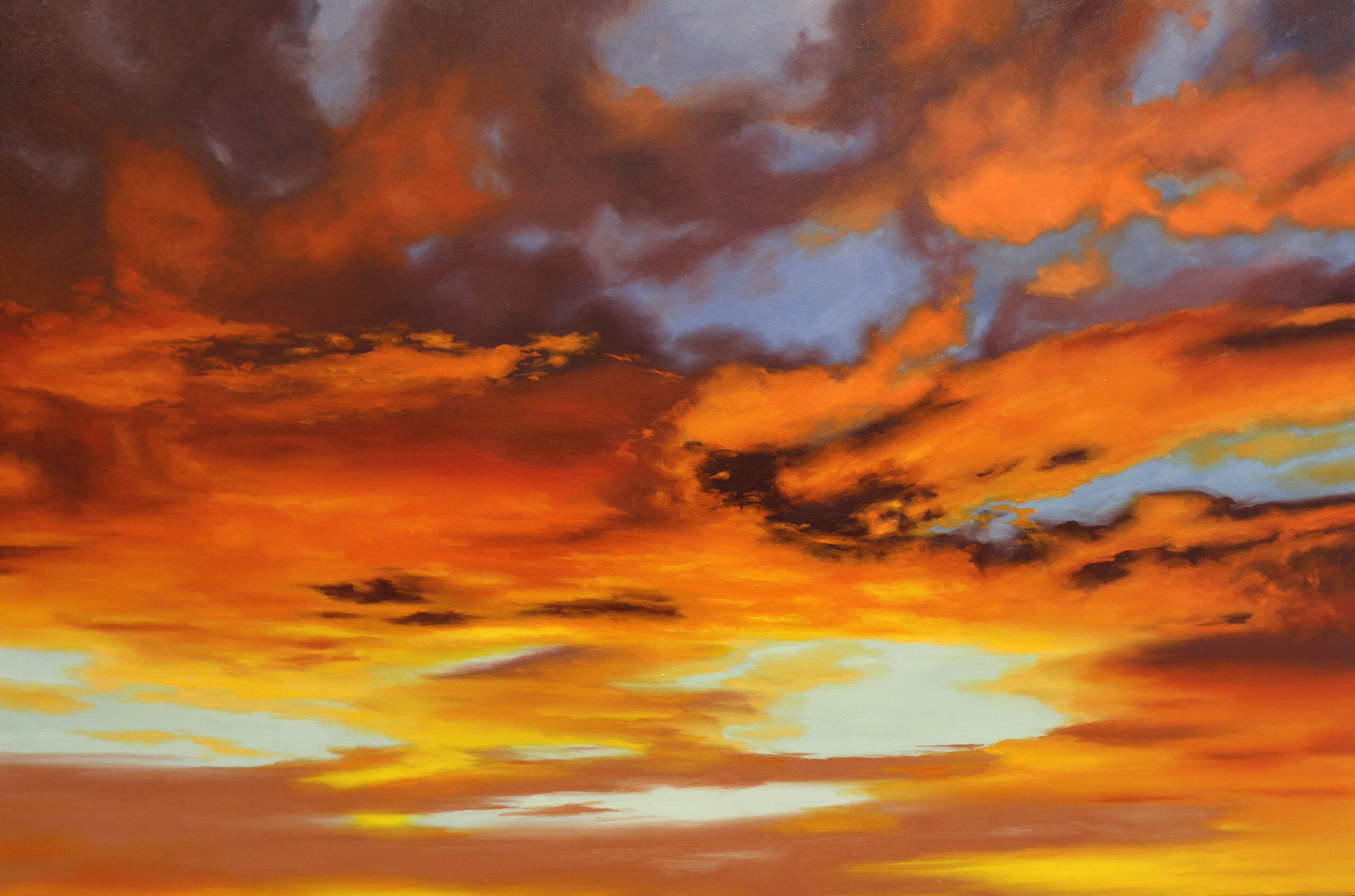 Colorful sunset sky with orange, yellow, and purple clouds, and a bright horizon line.