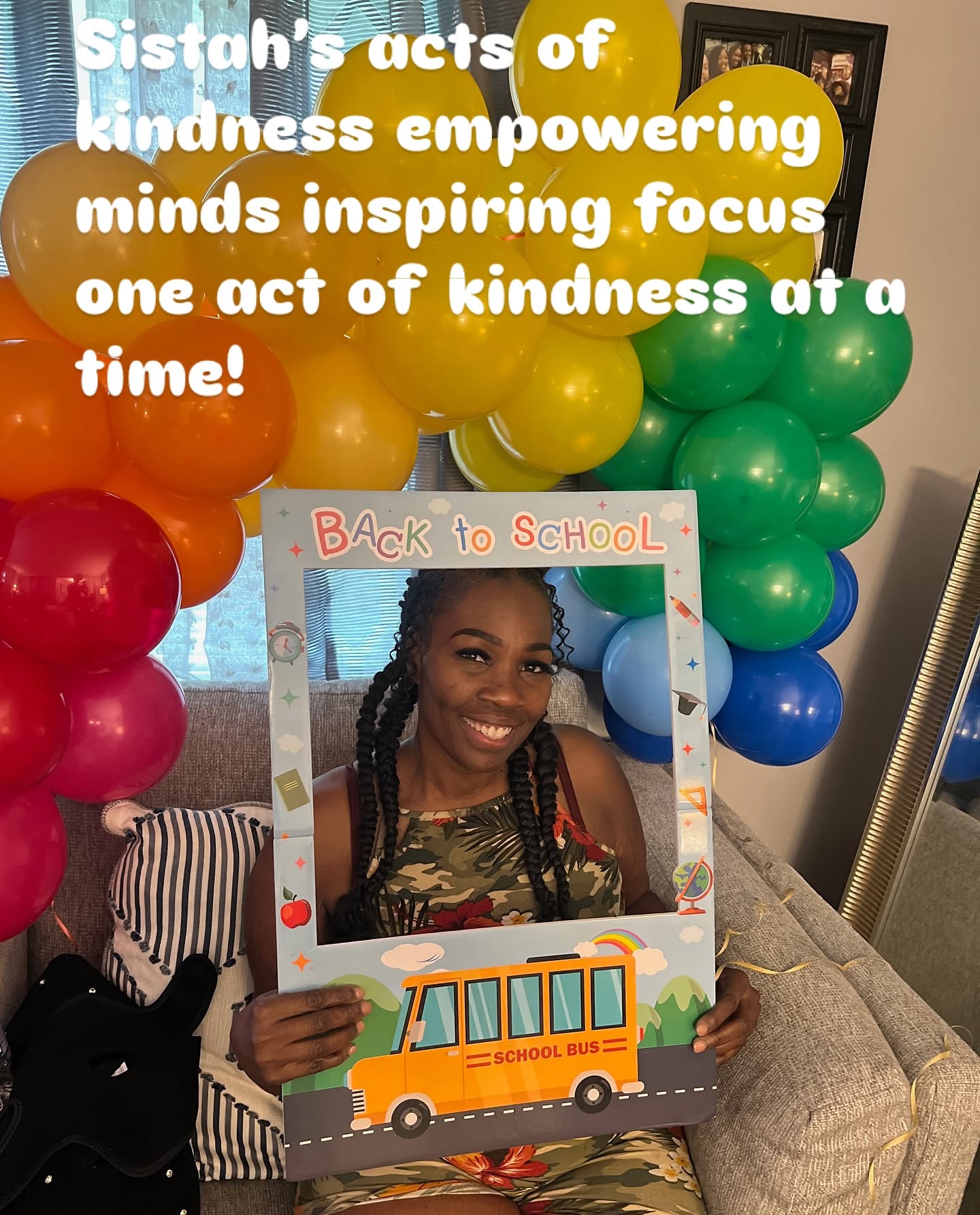 Person holding a colorful frame with a smiling girl inside, balloons in background, and a sign reading 'Back to School'.