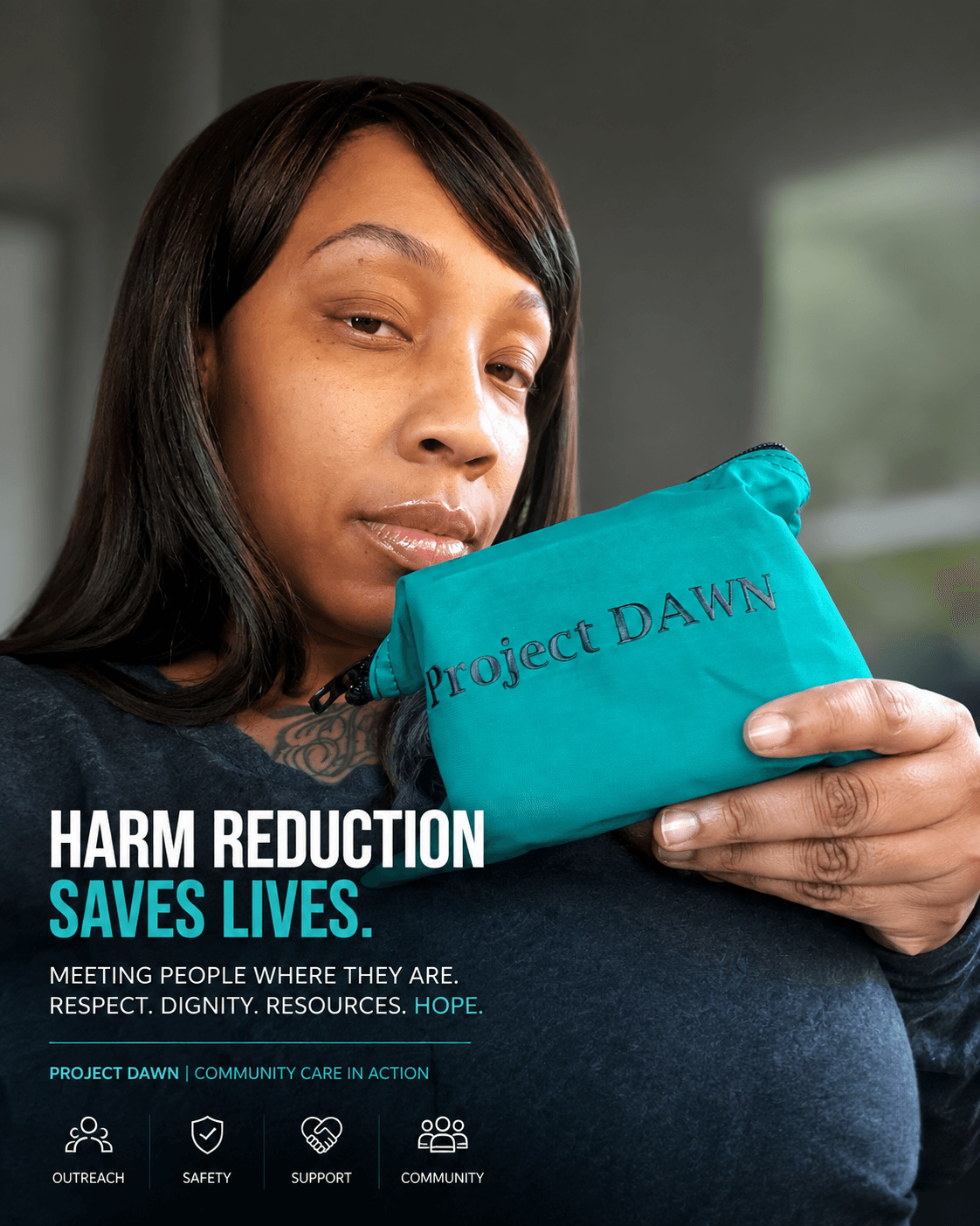 Woman holding a teal pouch with 'Project DAWN' written on it, looking at the camera, indoors with a window in the background.