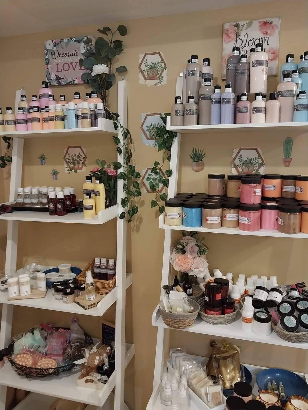 Shelves filled with bottles, jars, and containers of beauty or skincare products, with decorative signs and plants in the background.