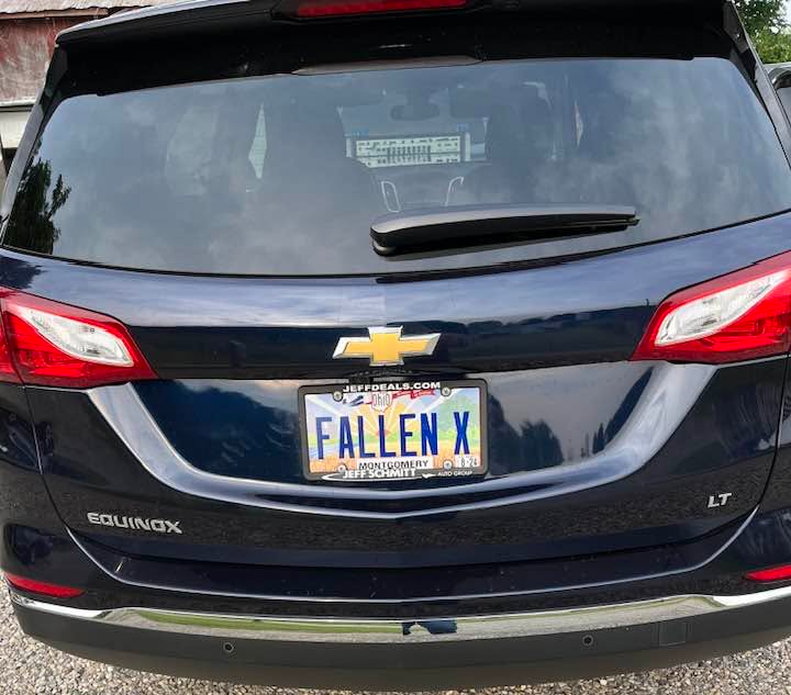 Rear view of a black Chevrolet Equinox with a license plate reading 'FALLEN X'.