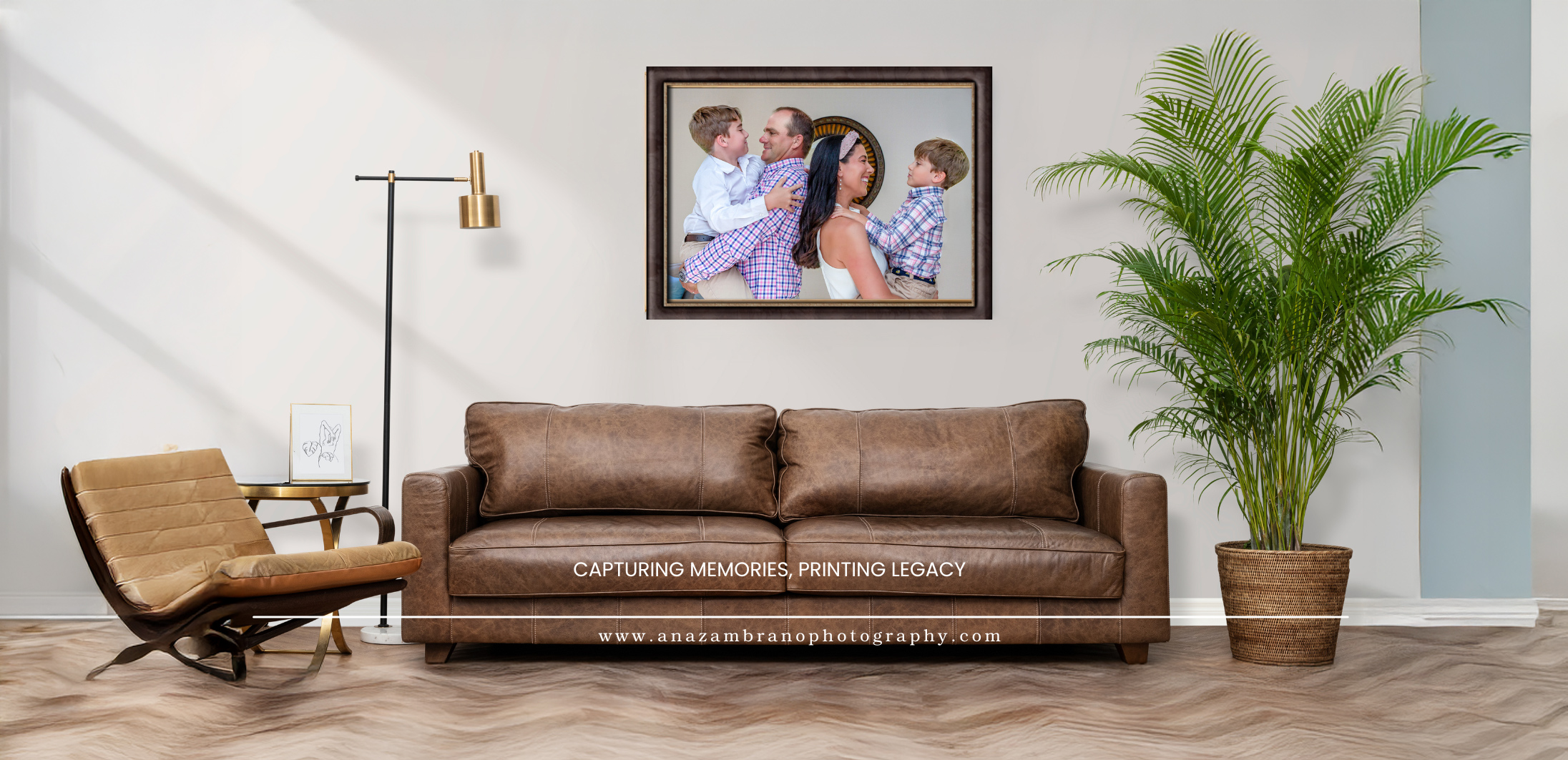 Living room with brown sofa, wooden chair, large potted plant, framed photo on wall, and floor lamp.