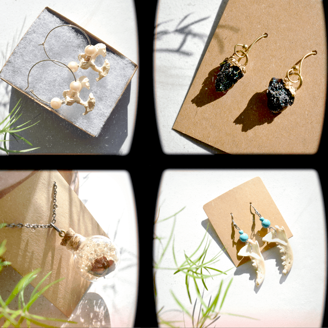Four pairs of handmade earrings displayed on cards and fabric, including shell, bead, and dark stone designs.