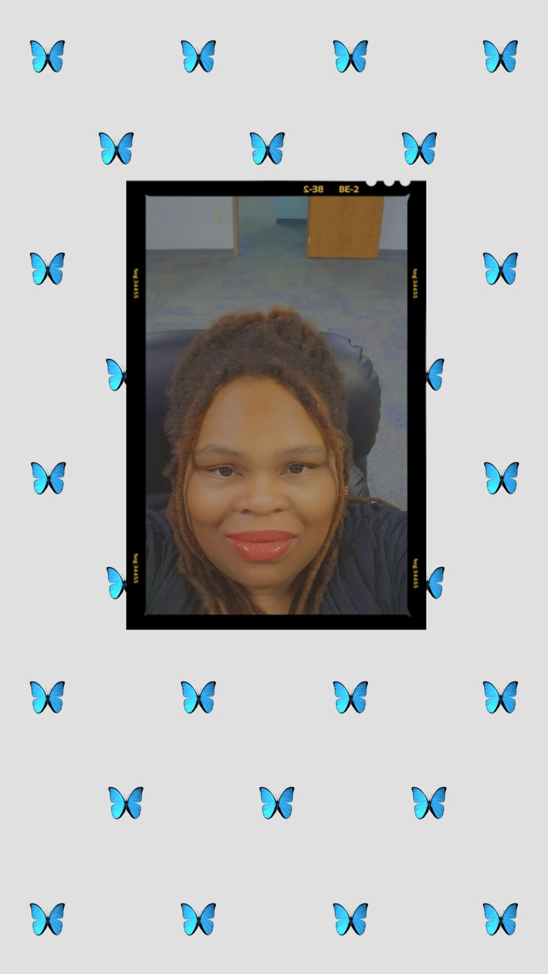 A woman with curly hair smiling at the camera, framed by a smartphone screen, with a background of blue butterflies on a light gray backdrop.
