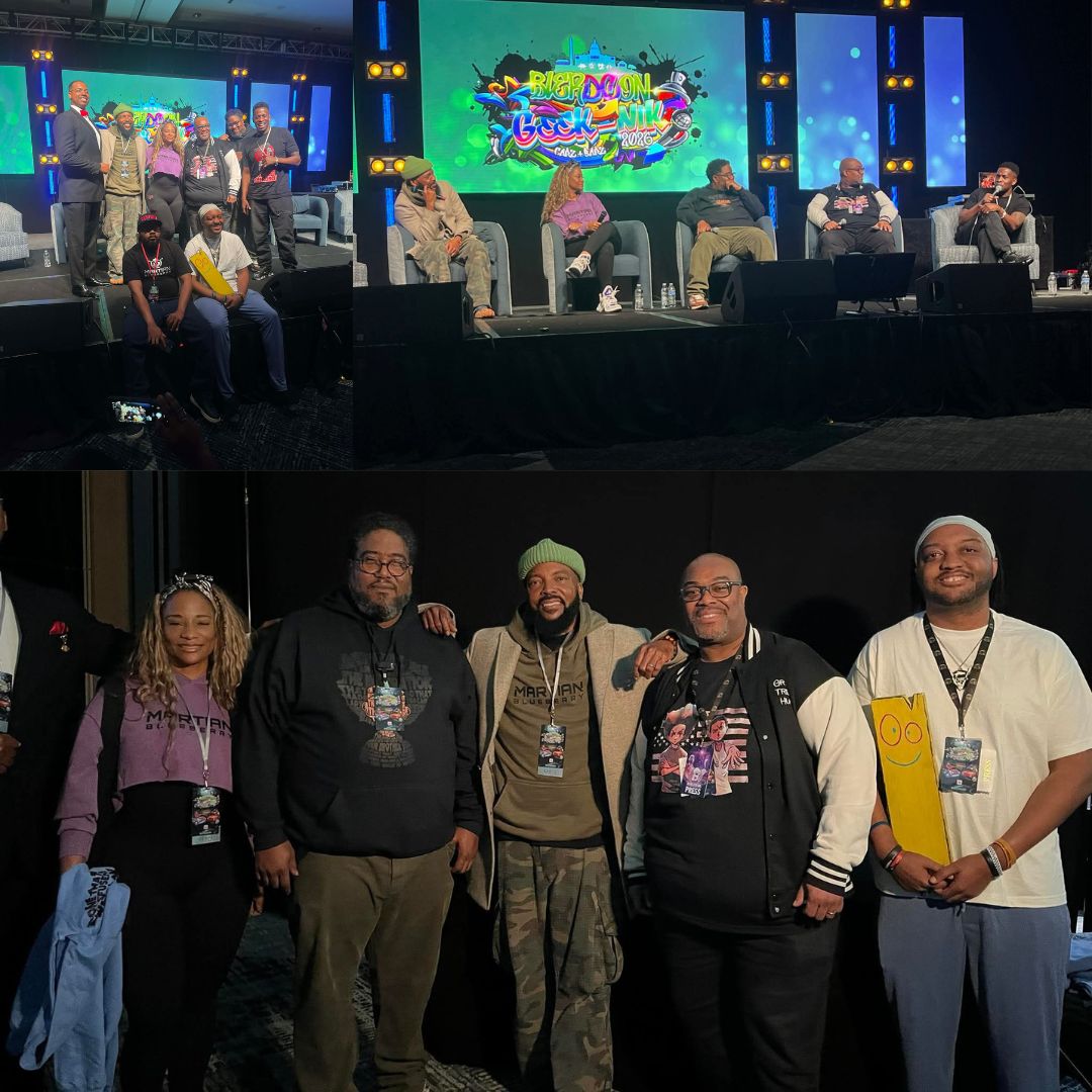 Group of five people standing on stage, smiling, with a black background and event badges, in front of a panel discussion. Word art on screen behind them.