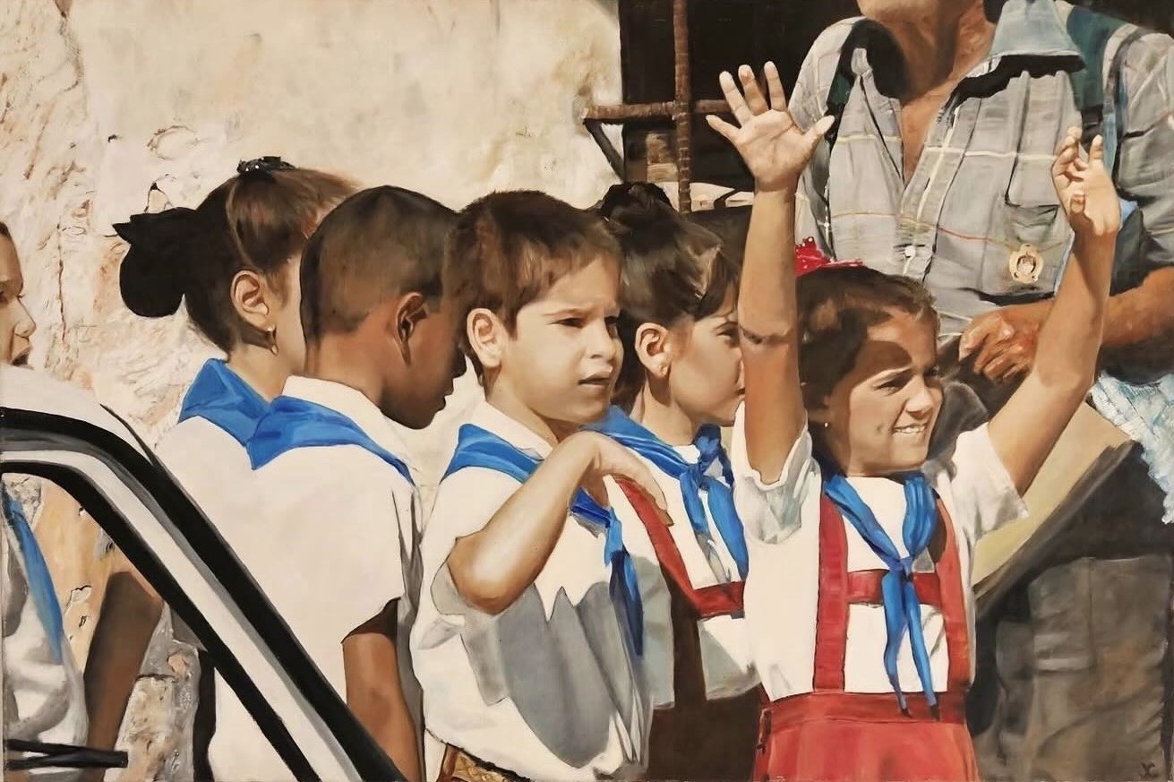 Children in white shirts and blue scarves wave beside a vehicle, with an adult standing behind them.